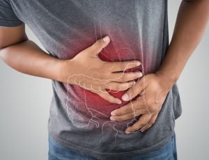 The photo of large intestine is on the man's body against gray background, People With Stomach ache problem concept, Male anatomy